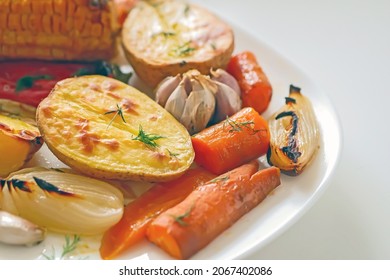 
Roasted
Vegetables In The Oven Potatoes, Peppers, Corn, Carrots, Onions Close-up On A White Plate. Vegan Homemade Vegetable Dish Background, Still Life Food, Delicious Juicy Baked Root Vegetables