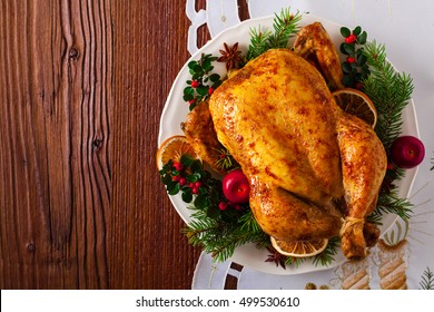 Roasted Whole Chicken With Christmas Decoration. Wooden Background. Top View. 