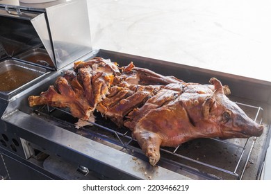 Roasted Whole Pig On A Stove Inside A Food Truck