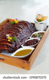 Roasted Whole Rib With Honey Served With Spicy, Sweet And Sour Dipping Come Along With Fried Potatoes.