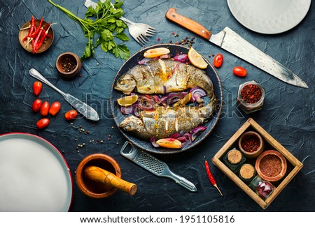 Roasted whole trout with lemon on plate.Delicious fried fish
