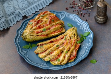 Roasted Zucchini Or Summer Squash Stuffed With Tomatoes, Cheese And Fresh Herbs On A Plate.