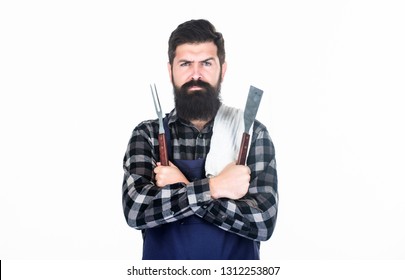 Roasting And Grilling Food. Man Hold Cooking Utensils Barbecue. Tools For Roasting Meat Outdoors. Picnic And Barbecue. Cooking Meat In Park. Masculine Hobby. Bearded Hipster Wear Apron For Barbecue.