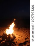 Roasting marshmallows over a nighttime fire on the beaches of Arch Cape on the Oregon Coast.