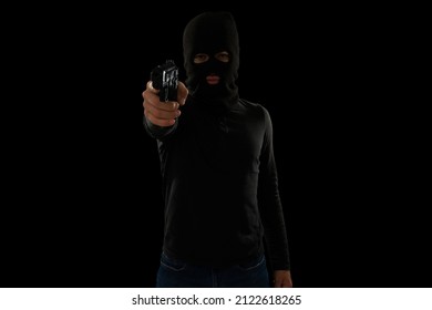 Robbed At Gunpoint. Dangerous Thief With A Black Balaclava Pointing A Gun To A Victim While Stealing Money 