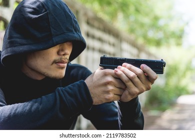 Robber Assassin Crime With Hood Points The Gun Already Shoot