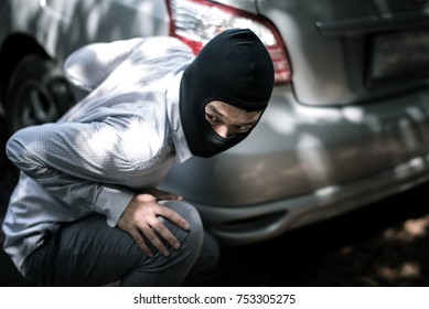 Robber In Black Mask With Car. Robbery And Crime Concept.