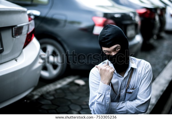robber\
in black mask with car. robbery and crime\
concept.