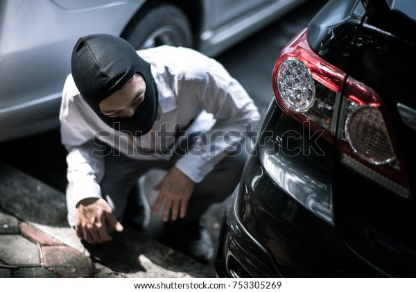 robber
in black mask with car. robbery and crime
concept.