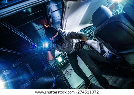Robber with Flashlight Inside Cargo Van at Night. 