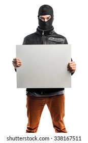Robber holding an empty placard