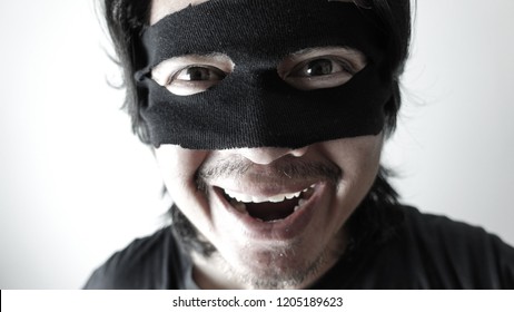 Robber Man With Black Mask Laughing, Thief Robbery Concept