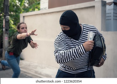 Robber snatching money from women on the street, Thief money concepts.