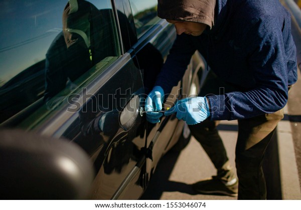 A robbery is breaking the law, hacks the lock on\
the car to get inside.