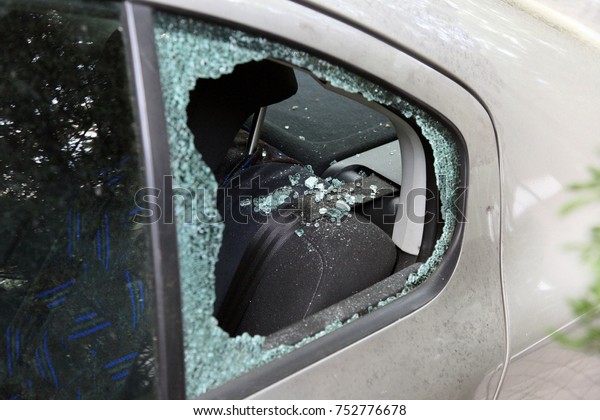 Robbery -\
closeup photo about a car\'s broken\
window