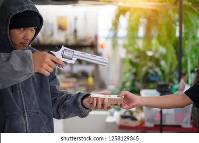 Robbery With Gun's. Gun And Money In A Hands. Bank Robbery, Man Carrying A Gun To Rob The Bank Note. To Threaten With The Man. A Murderer Attacking Holding Gun Kidnapping Business Young Person. 