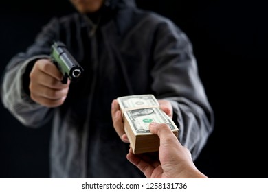 Robbery With Gun's. Gun And Money In A Hands. Bank Robbery, Man Carrying A Gun To Rob The Bank Note. To Threaten With The Man. A Murderer Attacking Holding Gun Kidnapping Business Young Person.