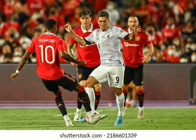 Roberto Firmino (white) of Liverpool battles for possession with Victor Lindelof of Manchester Utd during the Match Manchester Utd and Liverpool at Rajamangala Stadium on  July12 2022,Bangkok Thailand