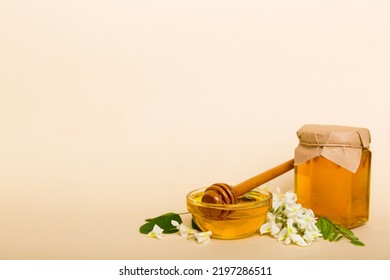 Robinia Honey Bollte With Acacia Blossoms On Colored Table.