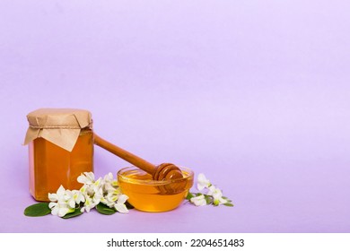 Robinia Honey Bollte With Acacia Blossoms On Colored Table.