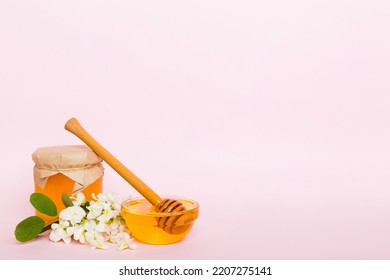 Robinia Honey Bollte With Acacia Blossoms On Colored Table.