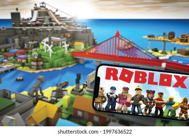 Roblox game app on the smartphone screen with the game blurred in the background. Top view. Rio de Janeiro, RJ, Brazil. June 2021.
