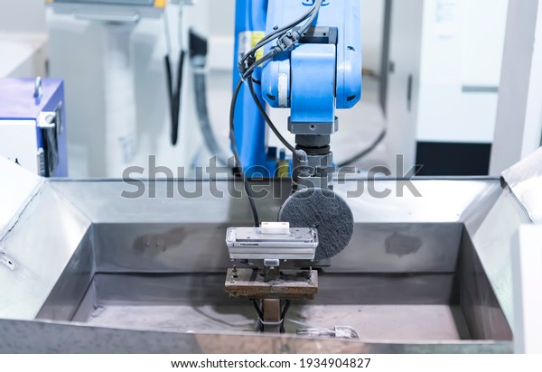 robot arm polishing the mobile phone part in the\
production line.