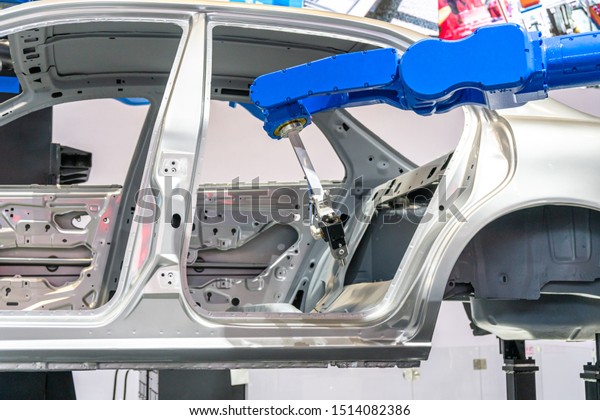 robot arm working in car\
assembly line