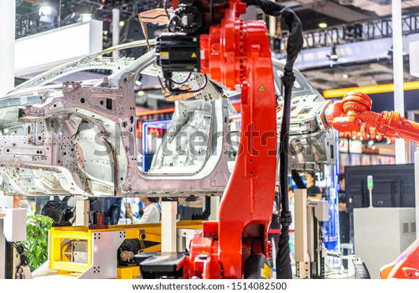 robot arm working in car
assembly line