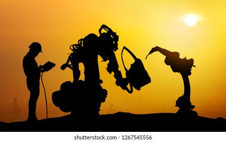 Robot Assistant Technology , Industry 4.0 , Artificial Intelligence Trend Concept. Silhouette Of Business Man Talking To Automation Robo Advisor Arm. Bokeh Flare Light Effect With Sunrise Background.