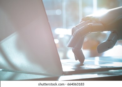  Robot Finger Point To Laptop Button. Chat Bot , Artificial Intelligence , Robo Advisor , Robotic Concept.