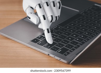 Robot hand finger typing or pressing enter on computer keyboard. Cyborg mechanical arm working with laptop. Artificial Intelligence futuristic design or chatbot concept. - Shutterstock ID 2309567399