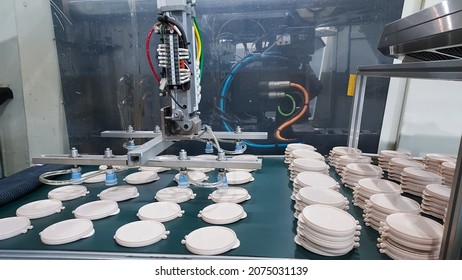 Robot Hand Holdind Plastic Bottles. From Plastic Injection Molding Machine. Of The Product Manufacturing And Assembly Department. In The Plastic Parts Factory.