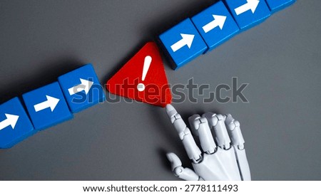 Robot Hand Touching a Red Warning Triangle Symbol on Gray Background Concept of Artificial Intelligence Error Handling and Risk Management