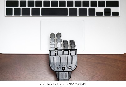 Robot Hand Typing Laptop Keyboard