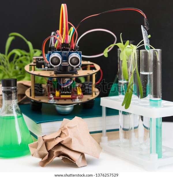 Robot handmade in the laboratory. Here are\
the plants, test tubes, microscope all around. STEM and STEAM\
education. An experiment in biology, robotics, chemistry, physics\
and mathematics.
