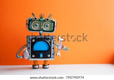 Robot handyman with hand wrench light bulb. Fixing maintenance concept. Creative design mechanic toy character. Orange wall, light floor background. Copy space.