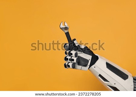 Robot holding an adjustable wrench tool in his hand isolated on an orange background. Concept of a robot master. Collaboration between humans and artificial intelligence.