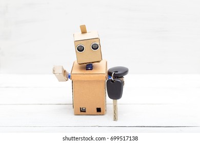 The Robot Holds The Car Keys In His Hand