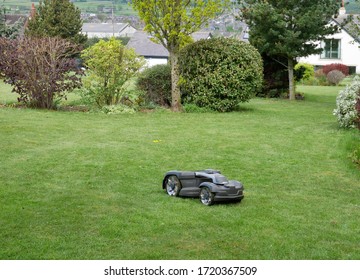 Robot Lawn Mower Cutting Grass In Back Garden Huddersfield Yorkshire England 02/05/2020 By Roy Hinchliffe