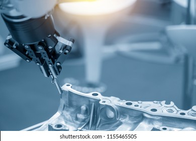 The robot for manufacturing  the aluminum automotive part .The automotive part quality control concept.