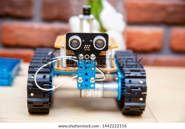 Robot on Wheels, managed by Computer,
original custom hot rod style automobile with unique design and
stylized environment with soft focus
background