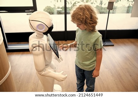 robot provide assistance to child. automation. artificial intelligence interact with boy