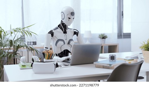 A robot resembling a human sits at a desk in an office, using a laptop to showcase the value of automation in repetitive and menial tasks. - Shutterstock ID 2271198779