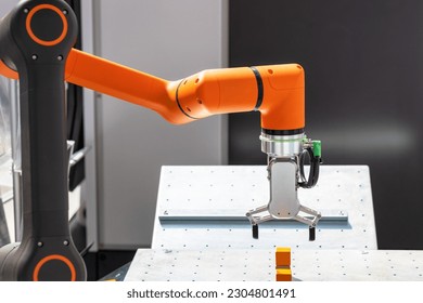 Robot or robotic arm for industrial pick and place, insertion, quality testing or machine tending - Shutterstock ID 2304801491