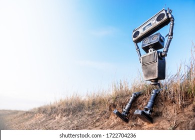 Robot with a tape recorder in hands against a blue sky