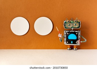 A robot tour guide with a pointer in his hand poses near two posters hanging on the brown wall of the museum. Copy space in billboard frames. Concept of visual art and robots guides