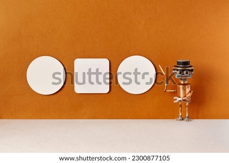 A robot tour guide with a pointer in his hand poses near three posters hanging on the brown wall of the museum. Copy space in billboard frames. Concept of visual art and robots guides.