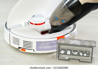 Robot Vacuum Cleaner Cleaning With Other Hoover. The Filter Lid Is Opened To Clean. Smart Cleaning And Washing Technology. Advanced Robot. Close Up