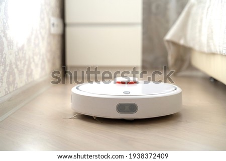 robot vacuum cleaner does cleaning in the apartment